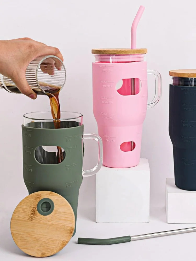32oz glass water bottle, glass drum with lid and straw, glass iced coffee cup with time marker and silicone cover, reusable